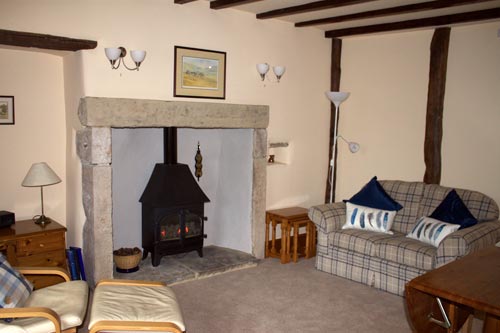 Lounge with beams and fireplace